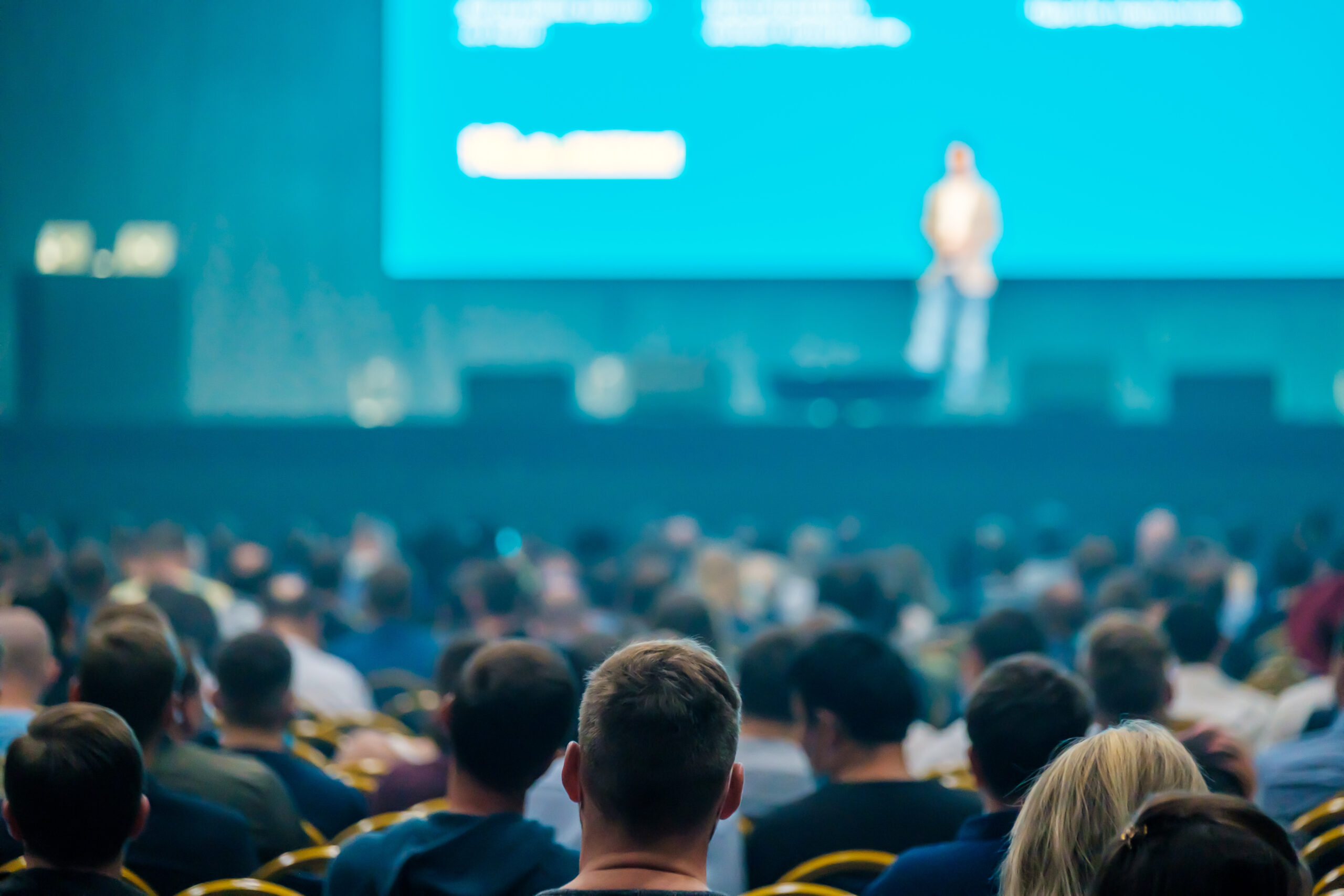Unrecognizable people listening to speaker during business conference auditoria presentation partner